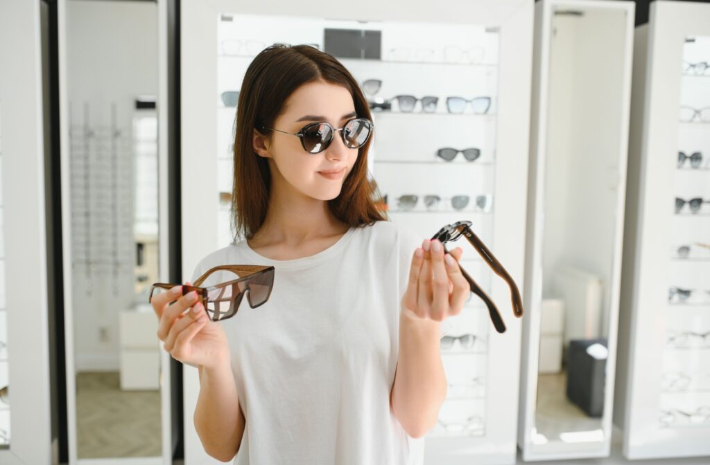 Woman trying on sunglasses in an optical store.